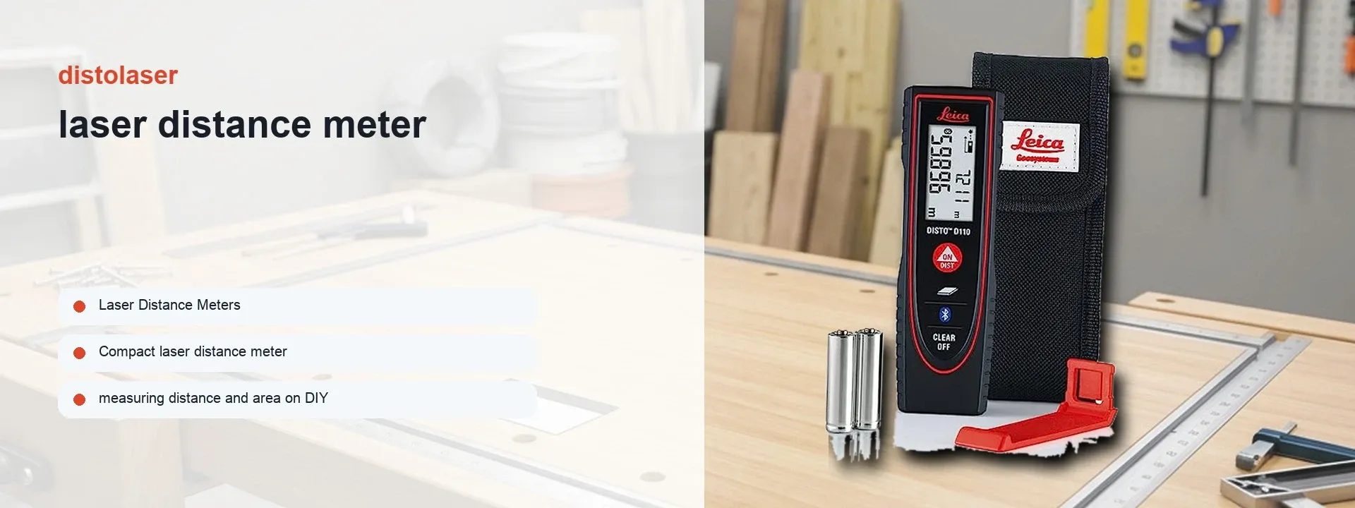 Leica DISTO D110 laser distance meter displayed on a workbench, showcasing its compact design and digital display.